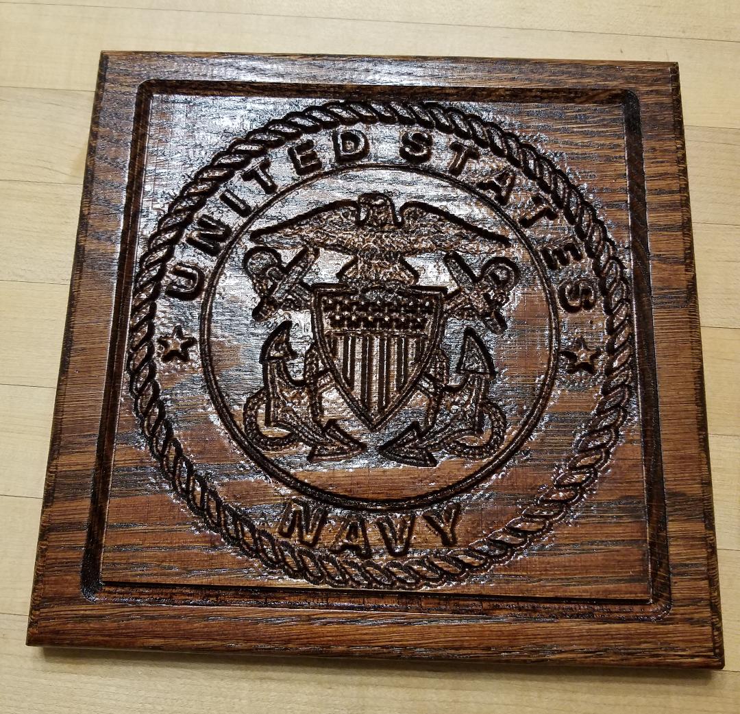 US Navy logo carved on wood