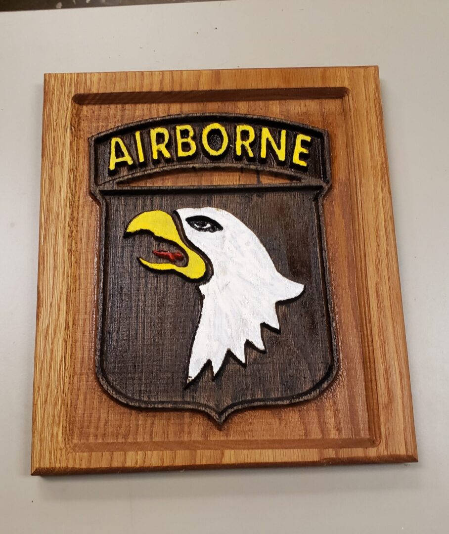 Airborne with a bald eagle carved on wood