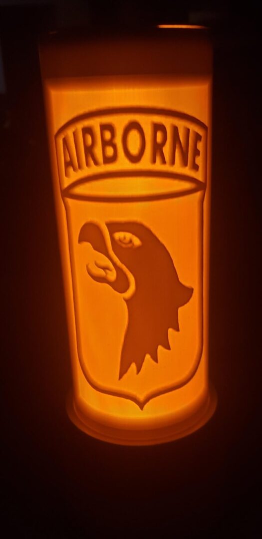 The logo of airborne with an eagle face glowing in the dark