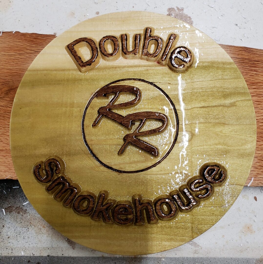 A wooden carving of double rr smokehouse