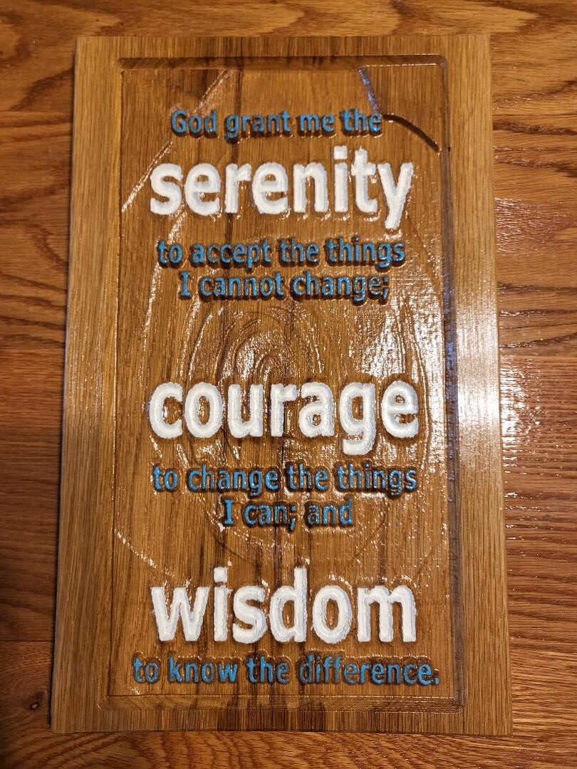 The wooden carving of Serenity Prayer painted