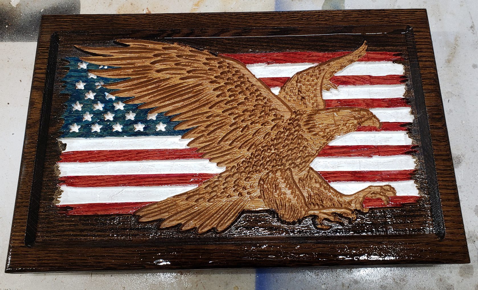 a wooden art of eagle and USA Flag